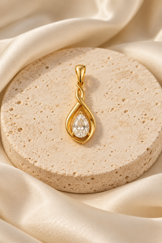 Gold pendant on cream stone and ivory fabric